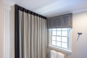 Elegant Louisville bathroom corner with light gray custom draperies and textured valance, crafted by Draped in Style, top local experts.