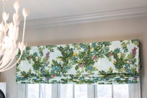 Louisville window with floral Roman shades in green, blue, and purple. Draped in Style delivers top custom drapery and cozy ambiance.